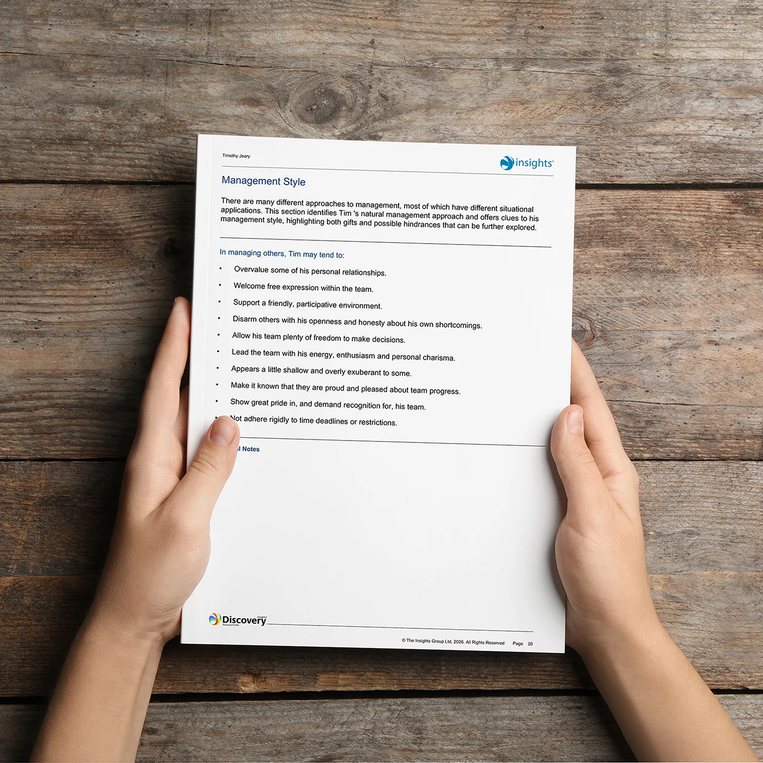 Hands holding an Insights Discovery report page outlining management style traits and behaviours